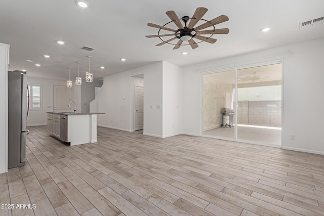 1857 W 22nd Ave, Apache Junction, AZ 85120 - kitchen with stainless steel appliances, ceiling fan, recessed lighting, light wood-style flooring, and open floor plan