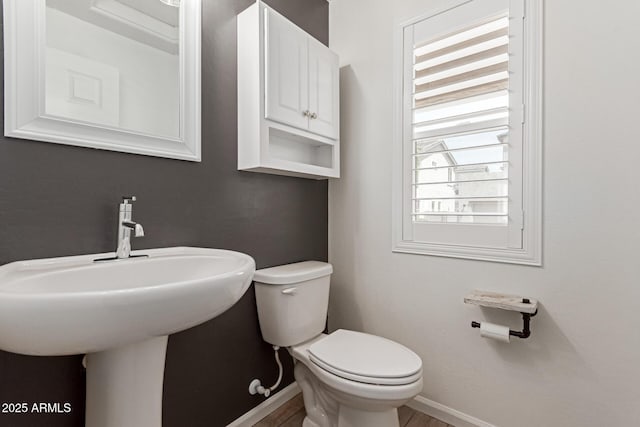 1857 W 22nd Ave, Apache Junction, AZ 85120 - half bathroom featuring baseboards, toilet, and a sink