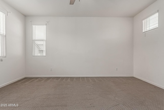 1857 W 22nd Ave, Apache Junction, AZ 85120 - carpeted spare room with plenty of natural light, a ceiling fan, and baseboards