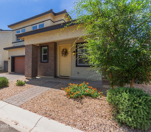 1857 W 22nd Ave, Apache Junction, AZ 85120 - view of front facade with stucco siding, a garage, and a porch