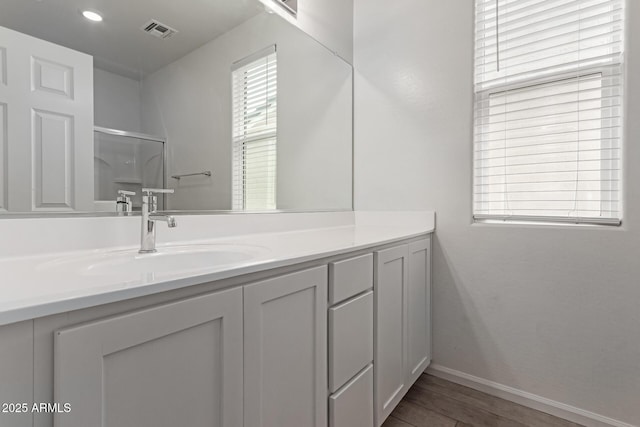 1857 W 22nd Ave, Apache Junction, AZ 85120 - bathroom featuring vanity, wood finished floors, baseboards, a shower, and recessed lighting