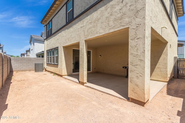 1857 W 22nd Ave, Apache Junction, AZ 85120 - back of house with stucco siding, a patio, a fenced backyard, and central AC unit