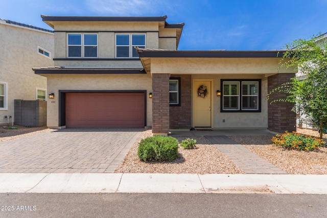 1857 W 22nd Ave, Apache Junction, AZ 85120 - view of front of house featuring an attached garage, stucco siding, covered porch, and decorative driveway