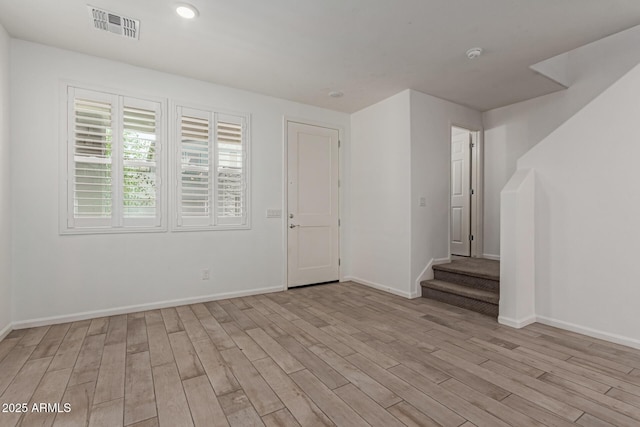 1857 W 22nd Ave, Apache Junction, AZ 85120 - unfurnished room featuring light wood-type flooring, baseboards, stairway, and a smoke detector