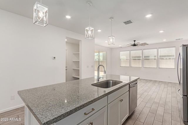 1857 W 22nd Ave, Apache Junction, AZ 85120 - kitchen with a sink, stainless steel appliances, an island with sink, light wood-type flooring, and stone countertops