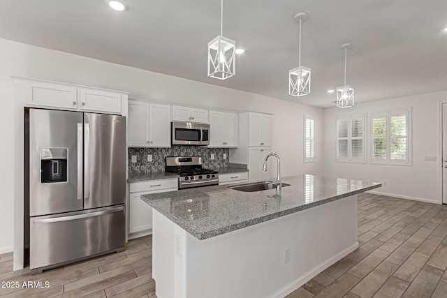 1857 W 22nd Ave, Apache Junction, AZ 85120 - kitchen with stainless steel appliances, wood tiled floors, a sink, white cabinets, and recessed lighting