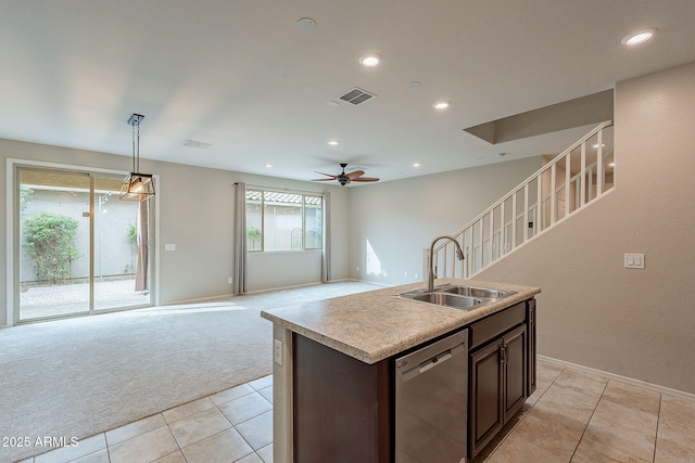 kitchen featuring visible vents, ceiling fan, a sink, stainless steel dishwasher, and light colored carpet