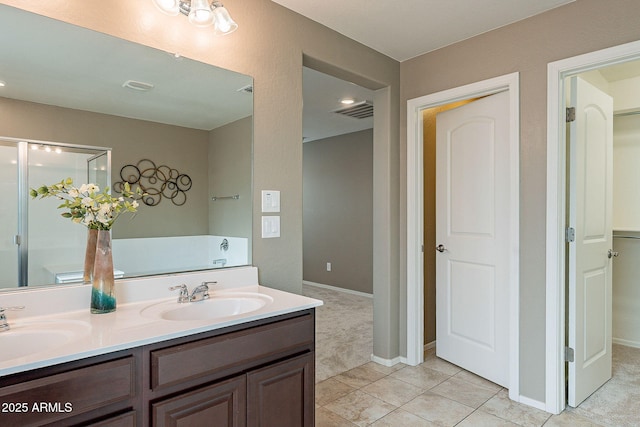 full bath featuring double vanity, visible vents, tile patterned floors, and a sink