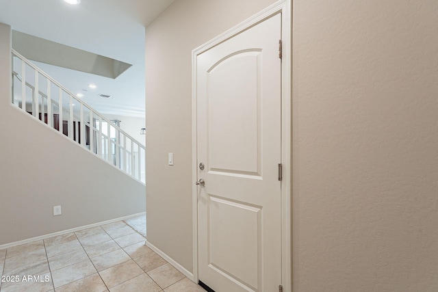 corridor with visible vents, recessed lighting, light tile patterned flooring, baseboards, and stairs