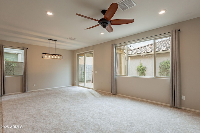 spare room with visible vents, recessed lighting, ceiling fan, and carpet floors