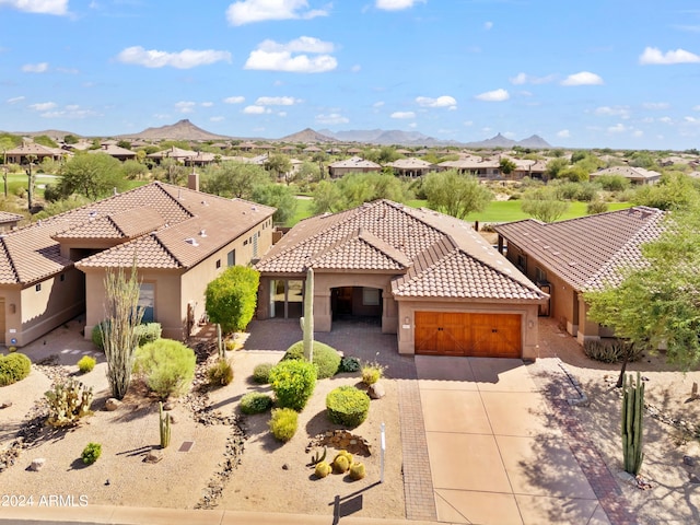 view of front of home with a mountain view and a garage