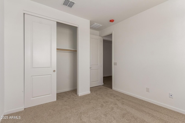 unfurnished bedroom with visible vents, baseboards, a closet, and carpet floors