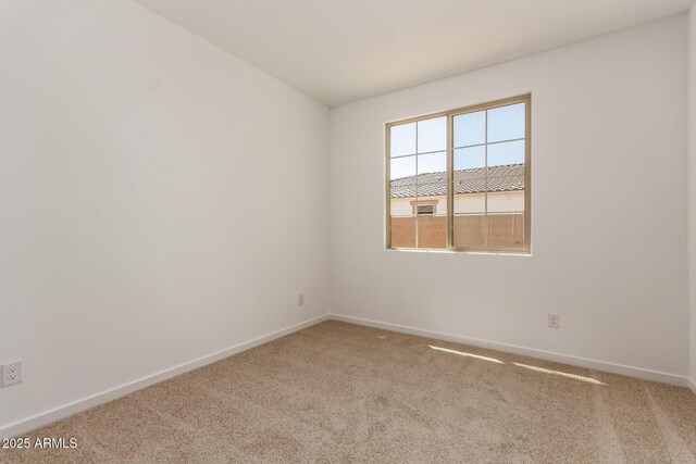 empty room featuring baseboards and carpet floors