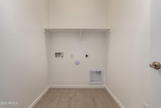 clothes washing area featuring electric dryer hookup, hookup for a gas dryer, washer hookup, light wood-style floors, and laundry area