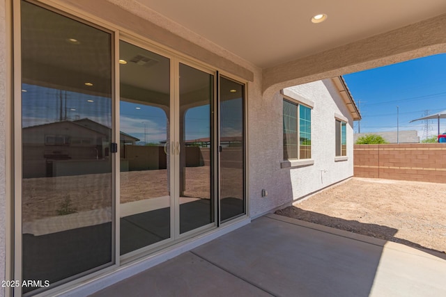 view of patio / terrace featuring visible vents and fence