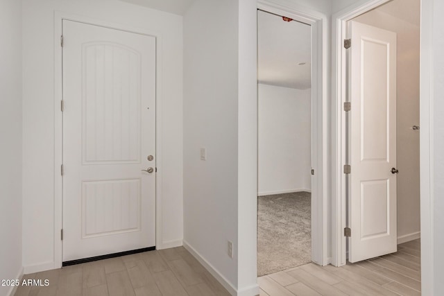 interior space with light wood-style flooring and baseboards