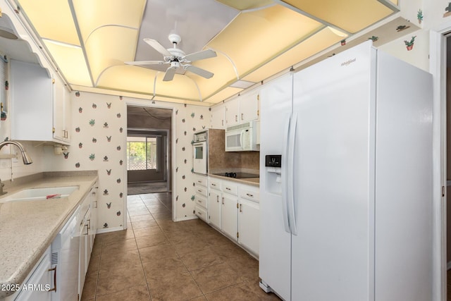 kitchen featuring light tile patterned flooring, white appliances, sink, and white cabinets