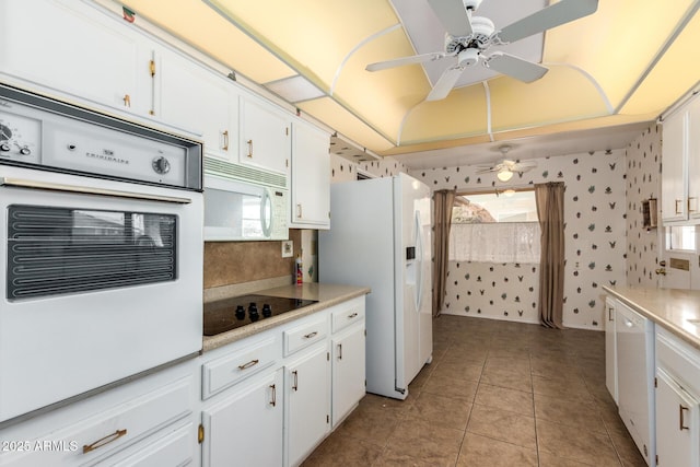 kitchen featuring light tile patterned floors, white appliances, white cabinets, and ceiling fan