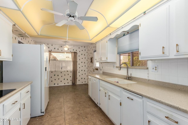 kitchen featuring white cabinetry, sink, light tile patterned floors, and white appliances