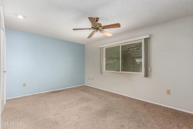 spare room with ceiling fan, carpet floors, and a textured ceiling