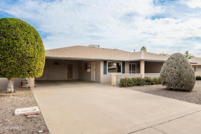 ranch-style house featuring a carport