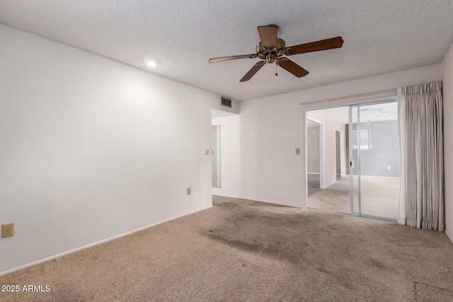 spare room with ceiling fan, carpet floors, and a textured ceiling