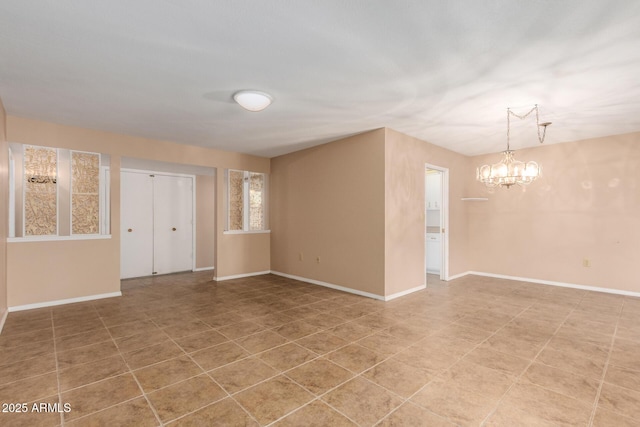 empty room featuring a notable chandelier