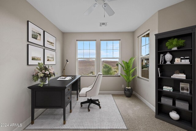 carpeted office featuring ceiling fan