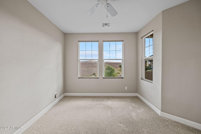 empty room with carpet flooring and ceiling fan