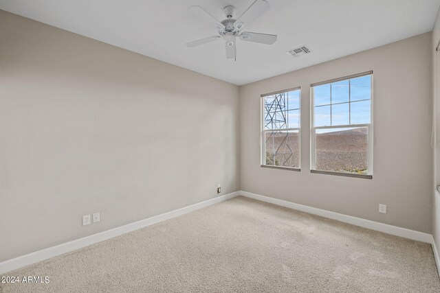 unfurnished room featuring carpet and ceiling fan