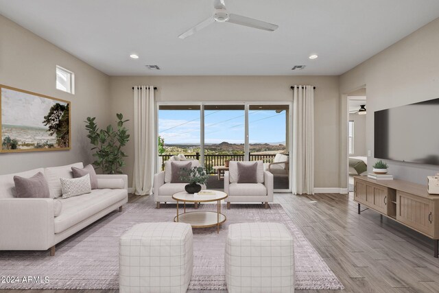 living room featuring light hardwood / wood-style floors and ceiling fan