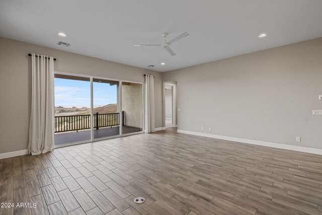 empty room with light hardwood / wood-style flooring and ceiling fan