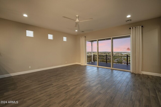 spare room with ceiling fan and dark wood-type flooring