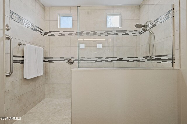 bathroom featuring a healthy amount of sunlight and a tile shower