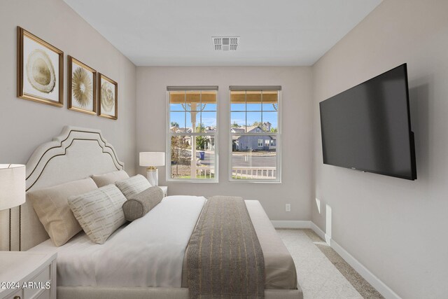 bedroom featuring light colored carpet