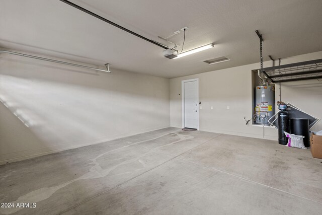 garage with water heater and a garage door opener