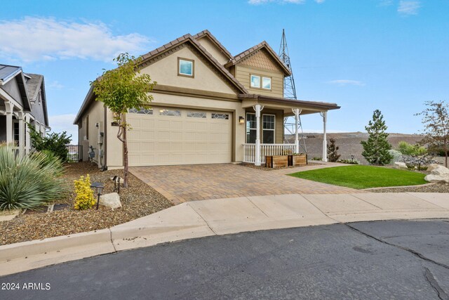 view of front of home featuring a garage and a porch