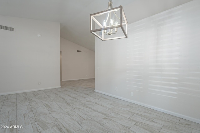 unfurnished dining area featuring vaulted ceiling and a notable chandelier