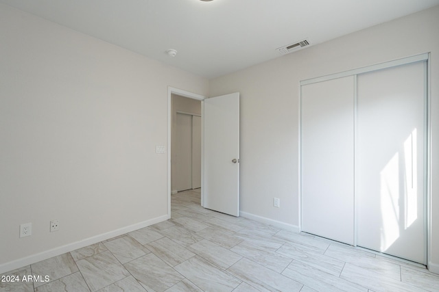 unfurnished bedroom featuring a closet