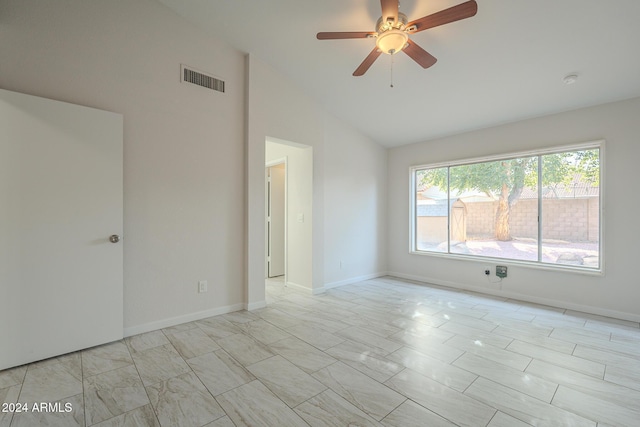 spare room featuring lofted ceiling and ceiling fan