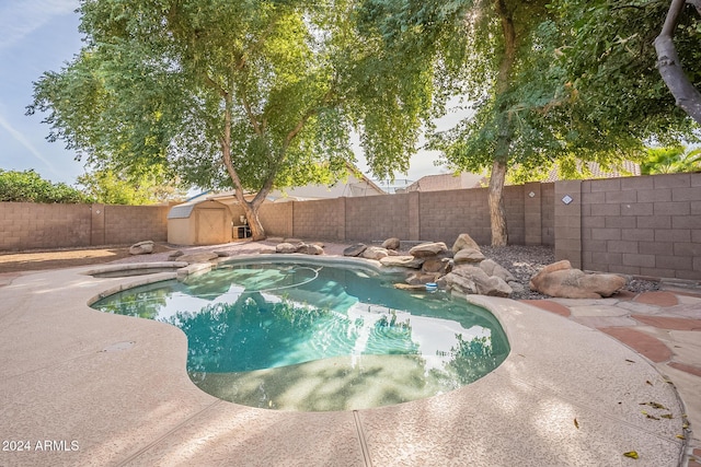 view of pool featuring a shed