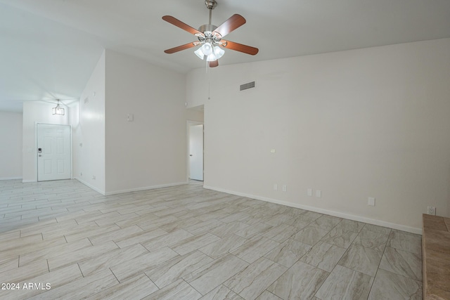 unfurnished room with ceiling fan and vaulted ceiling