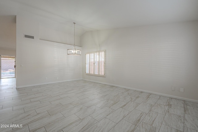 unfurnished room with a notable chandelier and high vaulted ceiling