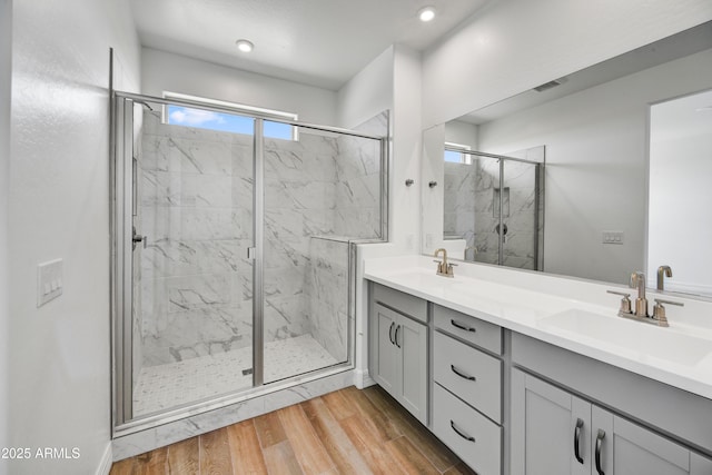 bathroom featuring vanity, hardwood / wood-style flooring, and walk in shower