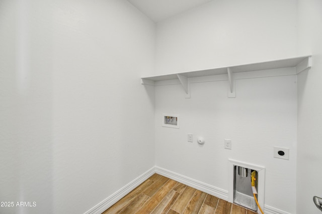 laundry area with hookup for a washing machine, gas dryer hookup, electric dryer hookup, and hardwood / wood-style floors