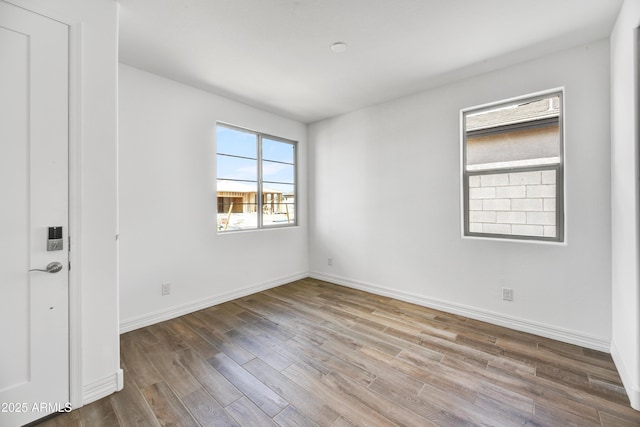 empty room with hardwood / wood-style flooring