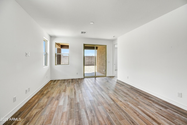 spare room with hardwood / wood-style floors