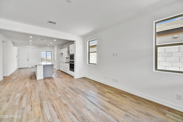 unfurnished living room with light hardwood / wood-style flooring