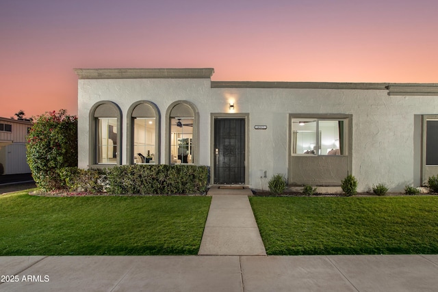 8317 E Orange Blossom Ln, Scottsdale, AZ 85250 - view of front of home with a yard and stucco siding