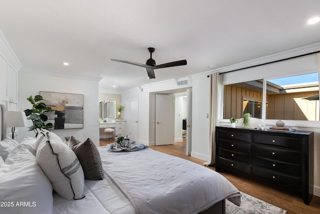 8317 E Orange Blossom Ln, Scottsdale, AZ 85250 - bedroom with ornamental molding, wood finished floors, recessed lighting, ensuite bathroom, and ceiling fan